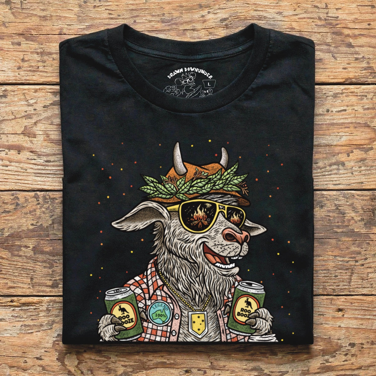 Close-up detail of black GOAT Greatest Of All Time t-shirt neckline showing custom tagless printed label with Drawn Downunder logo and small goat graphic - funny Aussie party goat tee