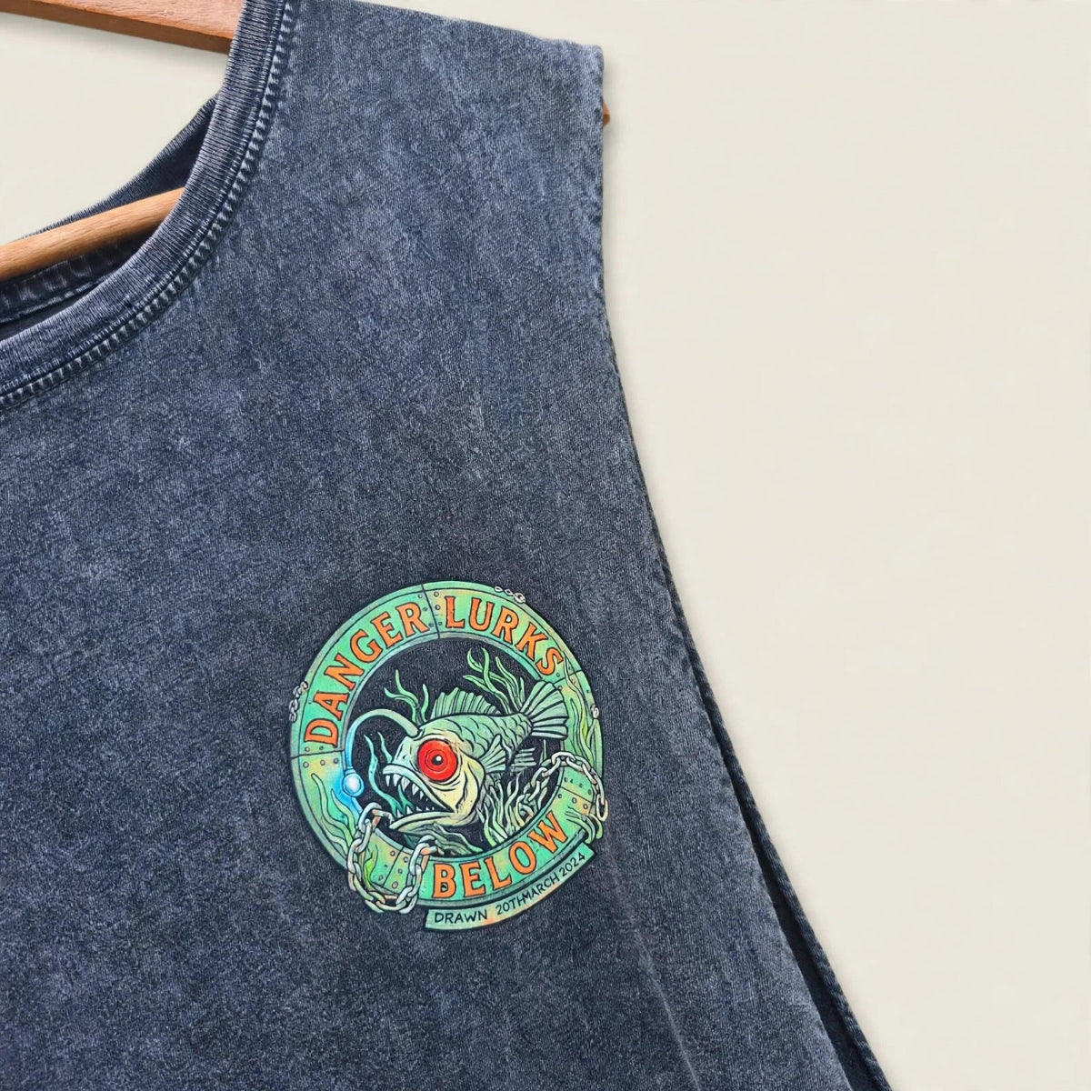 Bad Buoys angler fish stonewash tank - black wash singlet with vintage Danger Lurks Below badge graphic. Fishing boating and sailing nautiacal print