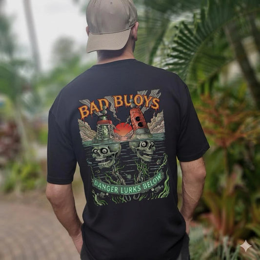 Bad Buoys t-shirt lifestyle back view - man wearing Danger Lurks Below skull buoys print outdoors - Drawn Downunder black tee